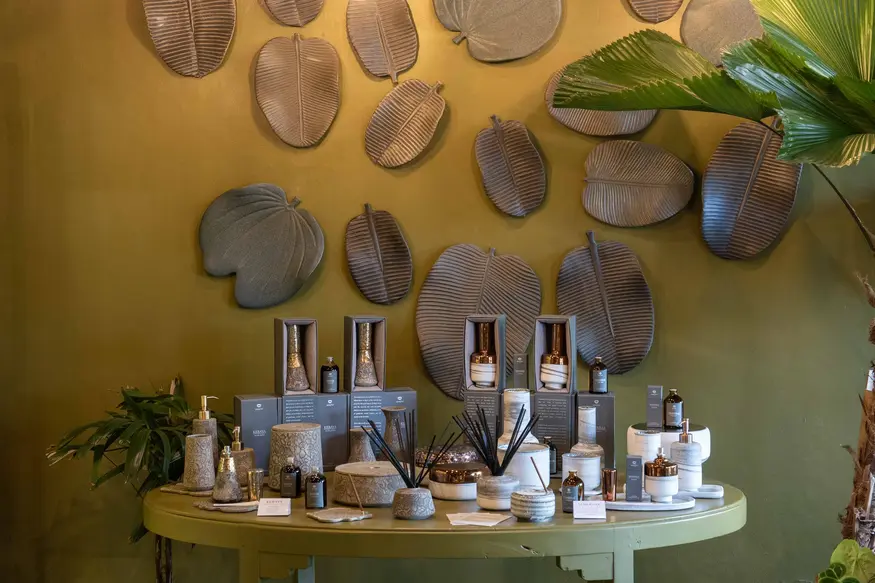 Wall of ceramic plates above bathroom amenity bottles