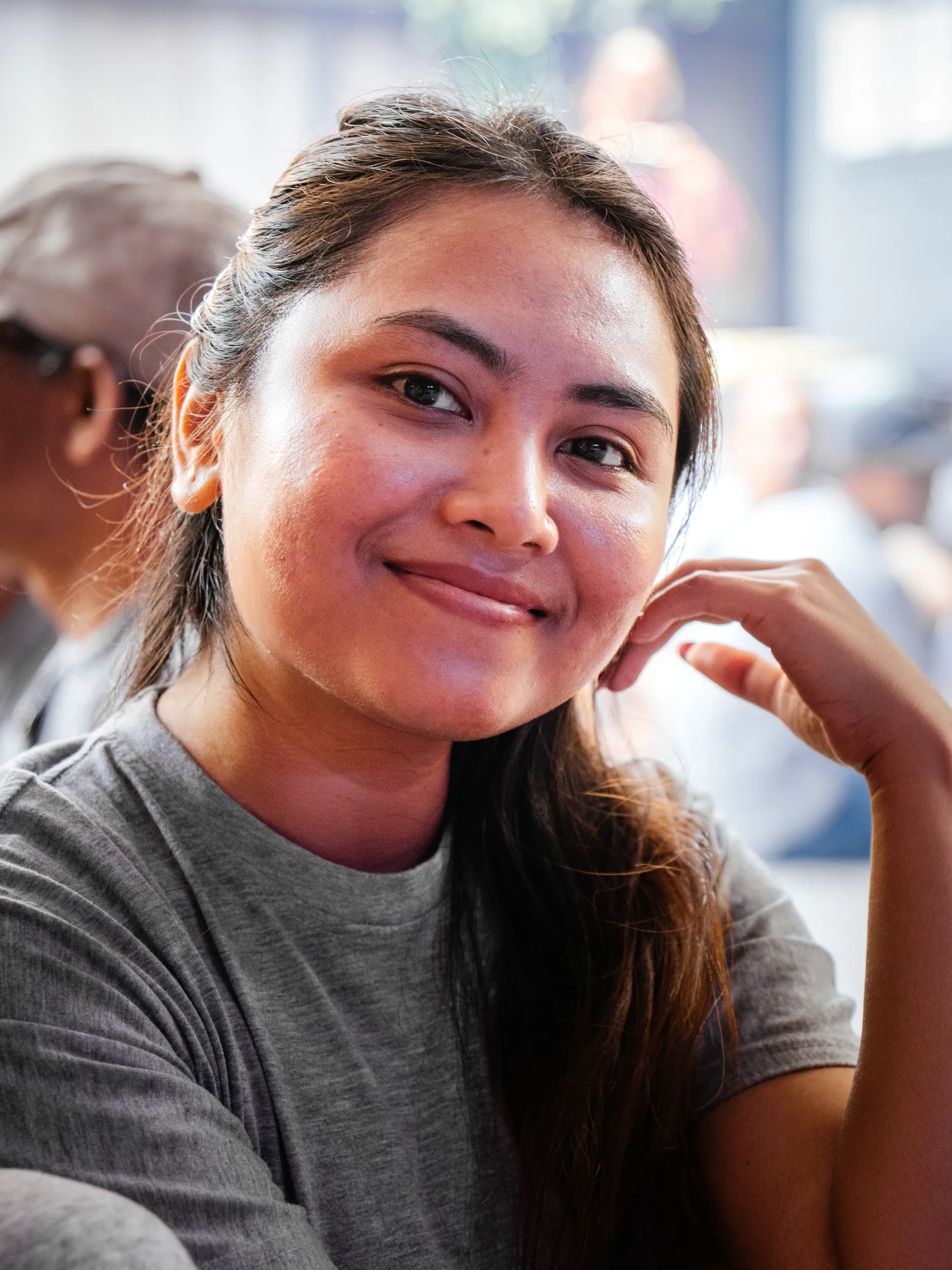 Portrait of a smiling Gaya Ceramic team member resting her chin on her hand